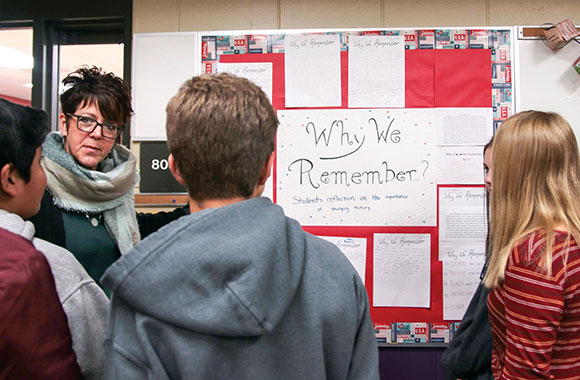 Jill Jones, an eighth-grade history teacher at Silver Lake Intermediate School in Oconomowoc, Wisconsin, reviews student reflections on the importance of remembering the Holocaust. Nicole Shaw